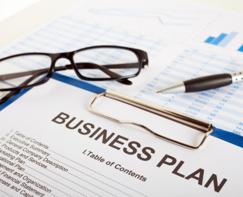 Clipboard with paper that reads Business Plan