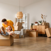 Young couple having fun in room on moving day